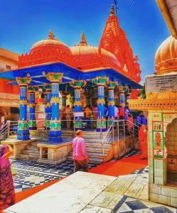 a group of people standing in front of a temple at Doctor Alone in Pushkar