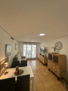 a living room with a couch and a table at Schöne Unterkunft mit Pool und Terrasse. in Denia