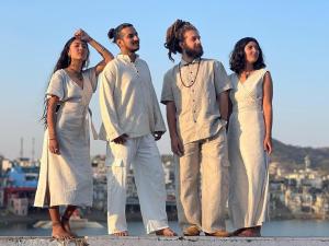 a group of men and women standing on a ledge at Doctor Alone in Pushkar