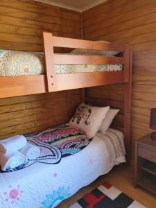 a bedroom with two bunk beds in a cabin at Cabañas ali in Puerto Aisén