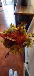 a pile of vegetables on the floor next to a table at Antigua Guatemala in Antigua Guatemala