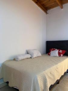 a bedroom with a bed with two pillows on it at La casita de Greis in La Unión