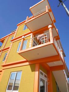 a colorful building with a balcony on it at RJ Residences in Roseau