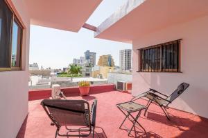 馬薩特蘭的住宿－Habitación Privada en Zona Dorada，阳台的天井配有2把椅子和1张桌子