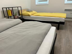 a room with three beds in a room at Penzion NoFasada in Bzenec