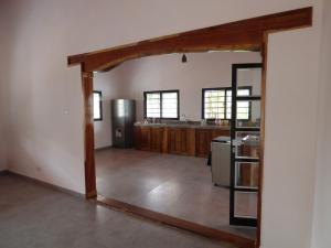 a living room with a kitchen and a large doorway at Casa Lamar in Sanyang