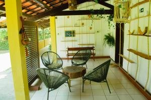 a group of chairs and a table on a porch at Pousada Paraíso do Vento in Cumbuco