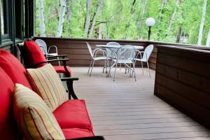a deck with chairs and tables and a table and chairs at Aspen West End Sanctuary 4878 sf. in Aspen