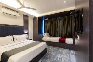 Postel nebo postele na pokoji v ubytování O Rooms Near Mumbai international Airport