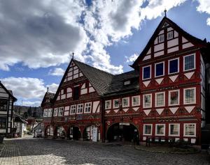 a large red and white building on a street at Fewo Dornröschen in Schieder-Schwalenberg