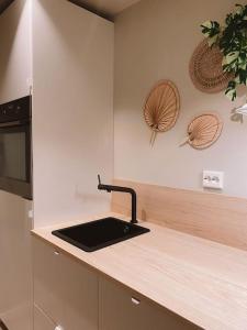 a kitchen with a sink and a counter top at Cute little appartment in Kristiansand