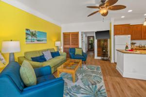 a living room with a couch and a table at Kiahuna Paradise at Poipu beach, newly remodeled in Koloa
