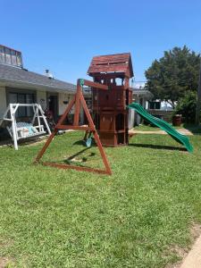 a playground with a swing set and a slide at Hunter's Friend Resort Near Table Rock Lake in Branson