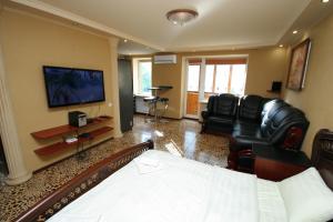 a living room with a couch and chairs and a television at Pechersk Apartment in Kiev Center in Kyiv