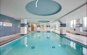 a large swimming pool in a building at Ultra Luxurious 2.5 Bedroom 2 Full Bathroom 1 Parking Condo Near SQ1 Striking Views in Mississauga
