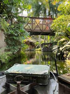 a bridge over a river with a suitcase on it at 4YOUnic: *2BR*55“TV*Balkon*Parkplatz in Leipzig