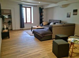 a living room with a couch and a table at Maison au cœur du Revermont in Ménétru-le-Vignoble