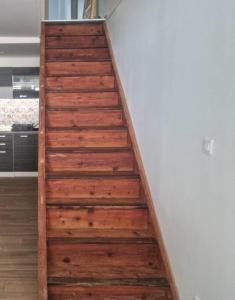 a wooden staircase in a room with a white wall at Maison au cœur du Revermont in Ménétru-le-Vignoble +30 photos