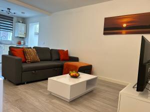 a living room with a couch and a tv at Modern 3 Bedroom House, Free Parking in Oxford in Oxford