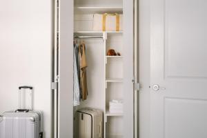 a closet with two suitcases sitting next to a door at Sonder at One Platt in New York