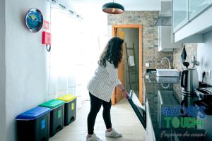 a woman standing in a kitchen looking into a sink at Atlântida Dream T2 in Angra do Heroísmo +3 photos