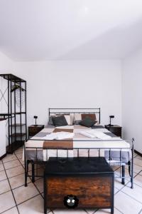 a large bed in a room with a table at Flat Mazzini 6 in Alzano Lombardo