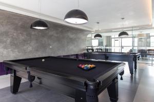 a billiard room with two pool tables in it at 7th Avenue Residence in Curitiba
