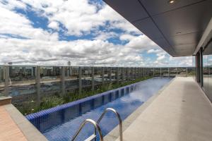 a swimming pool on the roof of a building at 7th Avenue Residence in Curitiba