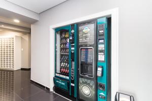 a vending machine in a room with a wall at 7th Avenue Residence in Curitiba