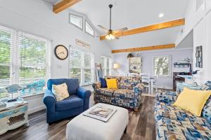 a living room with blue chairs and a clock at 4720 Summer Ln in Kitty Hawk
