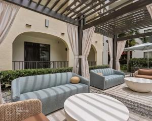 a patio with a couch and chairs and a table at Tampa Tropical-10 Min to Airport in Tampa