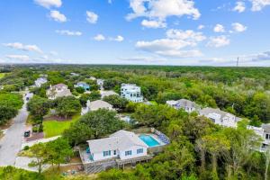 an aerial view of a home with a pool and trees at 4720 Summer Ln in Kitty Hawk