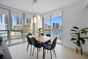 a dining room with a table and chairs at Hallandale Sky Water View in Hallandale Beach