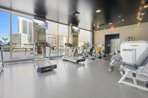 a gym with treadmills and machines in a building at Hallandale Sky Water View in Hallandale Beach