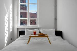 a bedroom with a bed with a table on it at Warsaw Castle Apartments - Prime Location, Historic City Center, Castle View, Fast Internet - by Rentujemy in Warsaw