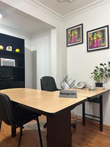 an office with a wooden table with a registration sign on it at Way Maker sede 2 in Bogotá