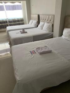 twee bedden naast elkaar in een slaapkamer bij LATORRE HOSTAL in Jaén