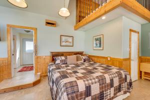 a bedroom with a bed and a staircase at Cozy Idaho Retreat with Grill and Fire Pit! in Caldwell