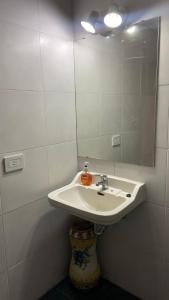 a bathroom with a sink and a mirror at Casa en el Encantador San Telmo - 8 habitaciones in Buenos Aires