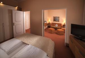 
a hotel room with two beds and a television at Hotel Vier Jahreszeiten Salzburg in Salzburg
