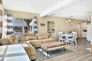 a living room with a couch and a table at Tropical Pelican Beach Home in Clearwater Beach