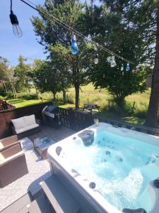 uma banheira de hidromassagem em cima de um pátio em Keer Side Lodge, Luxury lodge with private hot tub at Pine Lake Resort em Carnforth