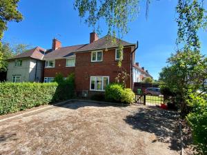 a large brick house with a large driveway at Room Wollanton Park Beeston near East Midlands Conference Centre train station tram stop in Nottingham