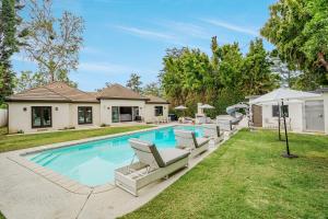 una piscina con tumbonas y una casa en Exquisite Oasis near Universal Studios with Large Pool en Los Ángeles