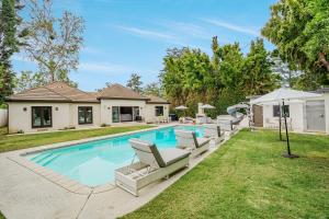 a swimming pool with lounge chairs and a house at Exquisite Oasis near Universal Studios with Large Pool in Los Angeles