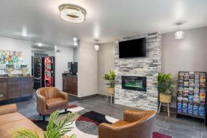 a lobby with a fireplace and a tv and chairs at Quality Inn in Jackson