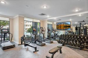 a gym with a lot of treadmills and machines at New Jax City Rooftop Pool in Jacksonville