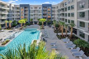 an image of an apartment complex with a swimming pool at New Jax City Rooftop Pool in Jacksonville