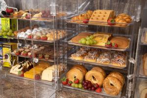 a display case filled with lots of different types of pastries at Rodeway Inn in Middletown