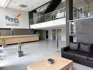 a lobby of a building with a couch and a table at Suite del sol 121 in Pinamar +18 photos